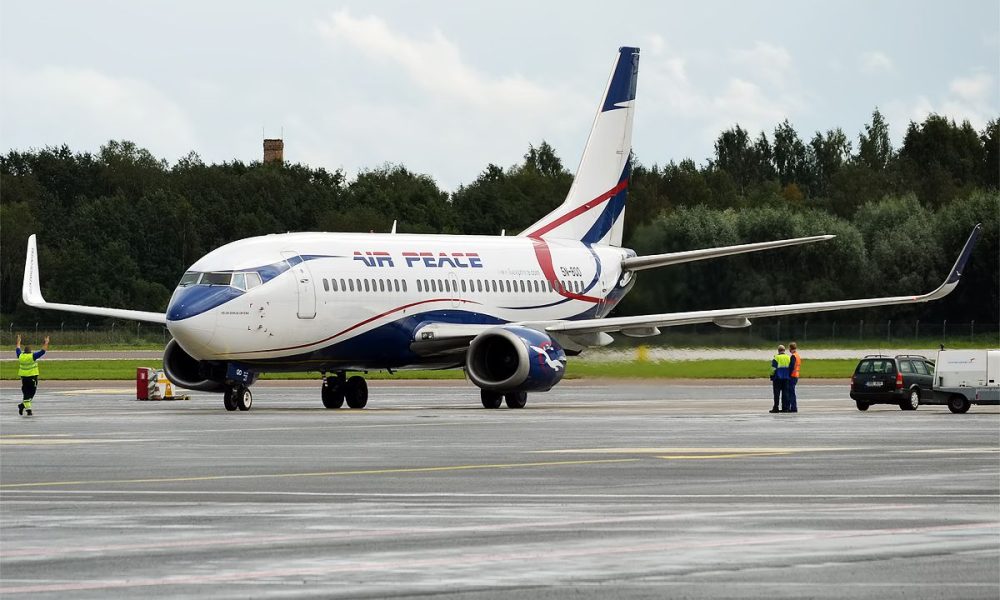 Air Peace Boeing 737 on the apron with maintenance crew around