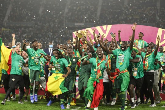 Senegal players celebrate with the trophy after winning the 2021 Africa Cup of Nations final soccer match against Egypt at the Paul Biya 'Olembe' Stadium, Yaounde, Cameroon 06 February 2022.