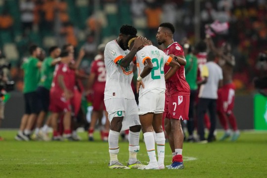 Ivory Coast's Franck Kessie, left, comforts his teammate Simon Adingra, after losing the African Cup of Nations Group A soccer match against Equatorial Guinea at the Olympic Stadium of Ebimpe in Abidjan, Ivory Coast, Monday, Jan. 22, 2024. (AP Photo/Sunday Alamba)