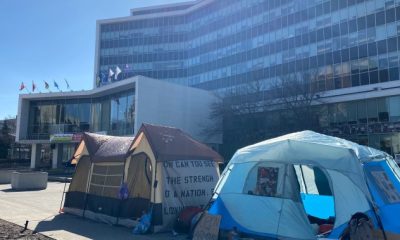 Tents pitched at Hamilton city hall prior to vote choosing parking lots over housing - Hamilton