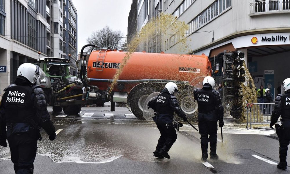 Watch: Angry farmers block streets, dump manure and clash with police in Brussels