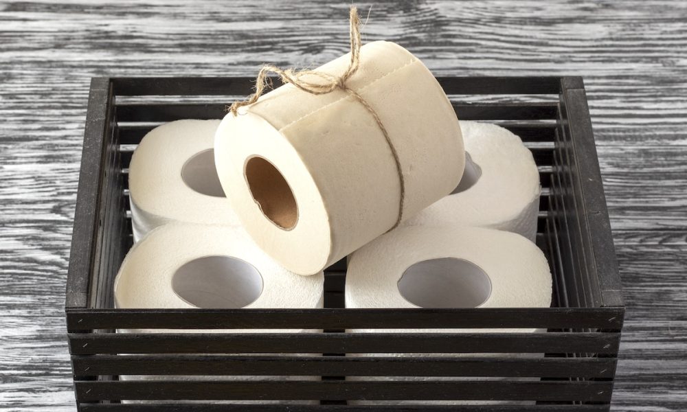Rolls of bamboo toilet paper in a black wooden box
