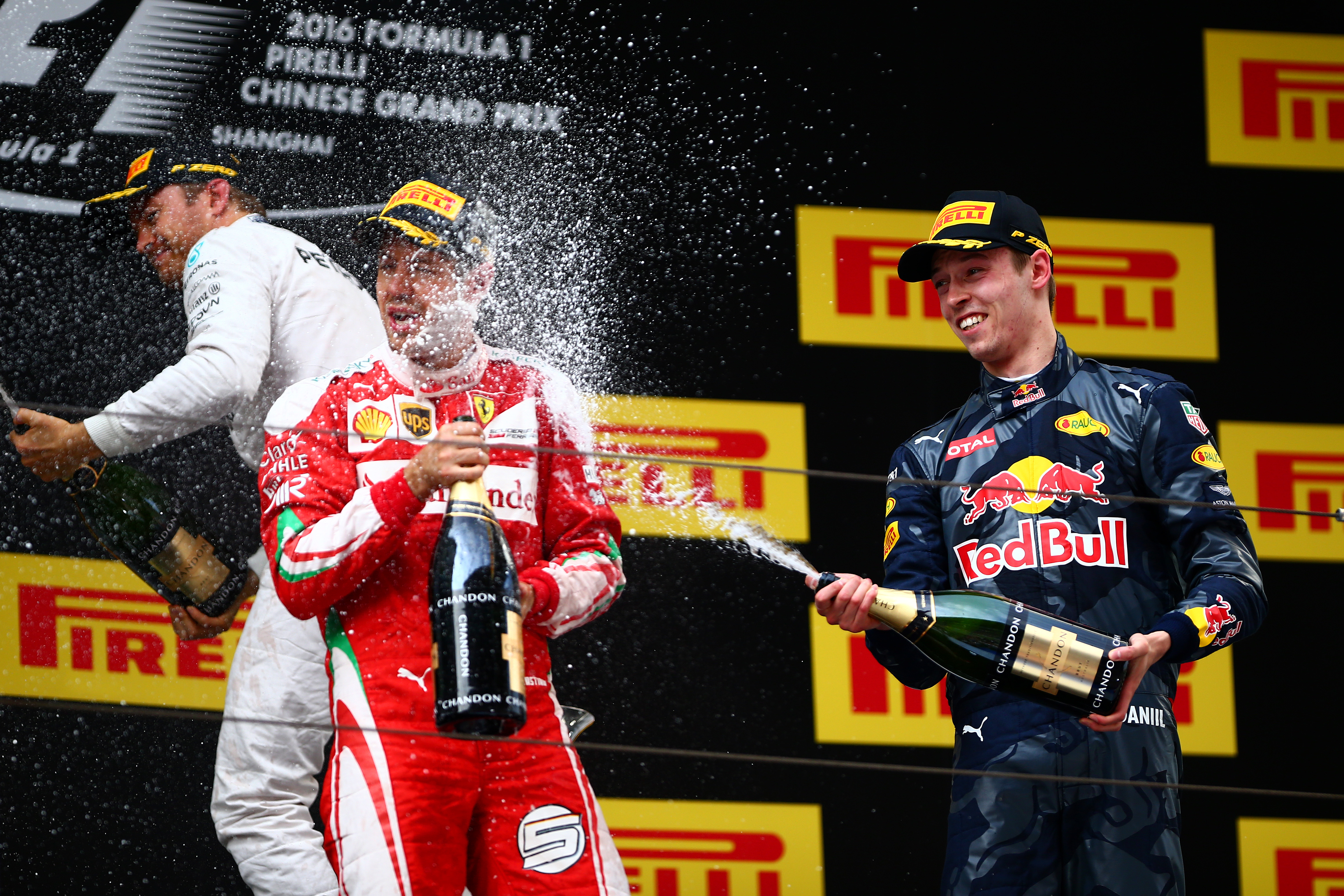 Kvyat and Vettel let their hair down after with a champagne shower as they became friends again