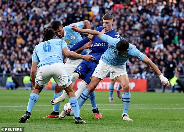 Chelsea forward Cole Palmer is crowded out by Nathan Ake, Rodri and Ruben Dias
