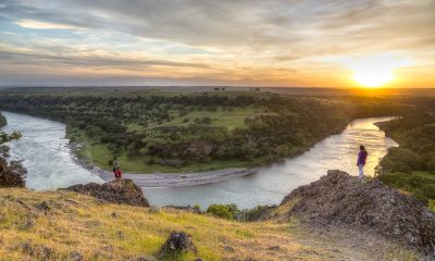 Hikers look out over the Sacramento River Bend Outstanding Natural Area in Red Bluff, California