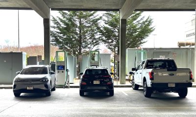 Three electric vehicles charging at Electricity America EV charging station in a parking garage at a shopping mall in Boston, Massachusetts