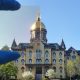 Notre Dame’s Golden Dome partially photographed through a sample (top left) of the new window coating researchers developed to block heat-generating ultraviolet and infrared light and allow for visible light, regardless of the sun’s angle