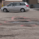 Southeast Calgary residents frustrated after strip mall parking lot potholes damage vehicles - Calgary