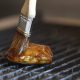 A chef brushes sauce on a piece of Good Meat's cultivated chicken at the Eat Just office in Alameda, California