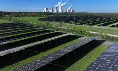 The Boxberg coal-fired power plant stands behind the newly inaugurated PV-Park Boxberg solar energy park in Nochten, Germany