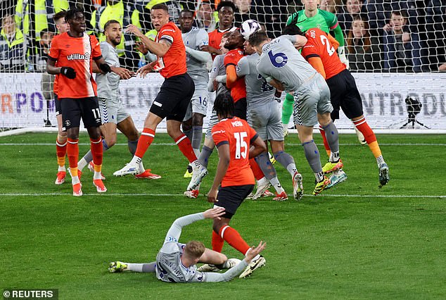 Branthwaite went down after being held by Mengi in the first half at Kenilworth Road